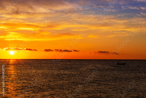 morning or evening landscape with nice beach during sunrise or sunset in sea with amazing isle with rocks and beautiful clouds on background