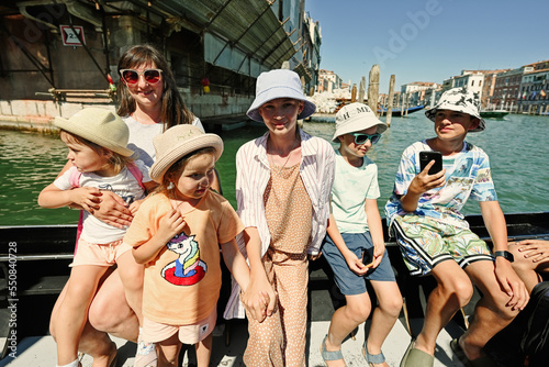 Large family in gondola , many kids with mother in Venice, Italy.