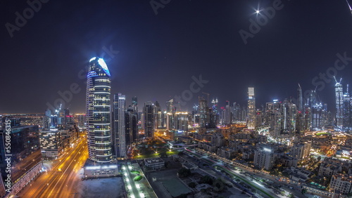 Dubai's business bay towers aerial all night timelapse. Rooftop view of some skyscrapers