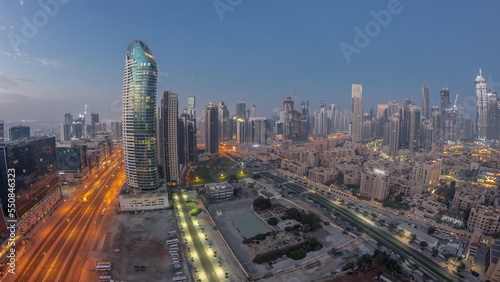 Dubai s business bay towers aerial night to day timelapse. Rooftop view of some skyscrapers
