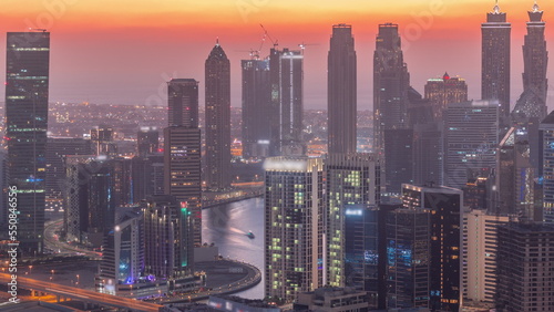 Skyline with modern architecture of Dubai business bay towers day to night timelapse. Aerial view © neiezhmakov