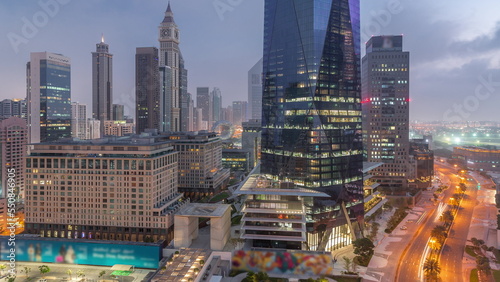 Dubai International Financial district aerial night to day timelapse. View of business office towers.