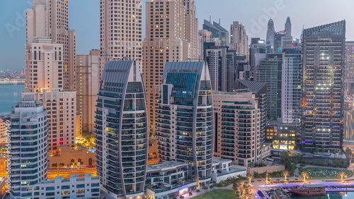 Dubai Marina skyscrapers and JBR district with luxury buildings and resorts aerial night to day timelapse © neiezhmakov