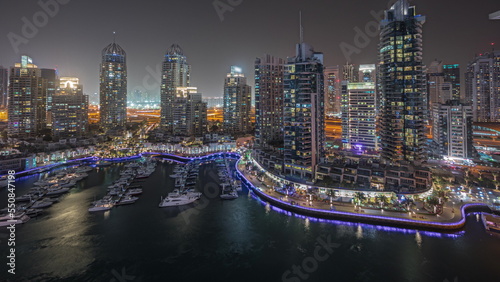 Panorama showing luxury yacht bay in the city aerial night timelapse in Dubai marina