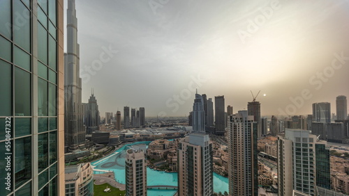Dubai downtown during sunrise with fountains and modern futuristic architecture aerial timelapse