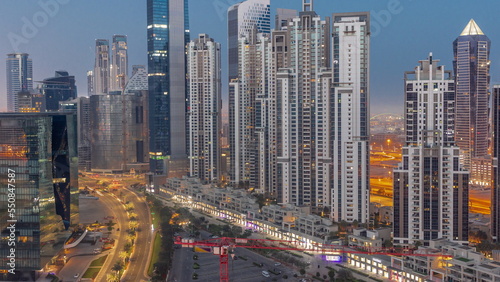 Bay Avenue with modern towers residential development in Business Bay aerial night to day timelapse  Dubai