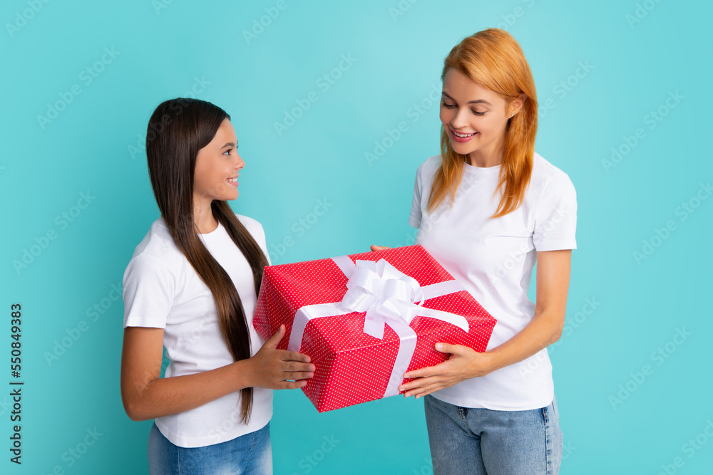 Love mom. Smiling mother and daughter with gift box. Cheerful mom and her cute daughter girl with gifts. Love mom. Smiling mother and daughter with gift box. Cheerful mom and her cute daughter girl with gifts.