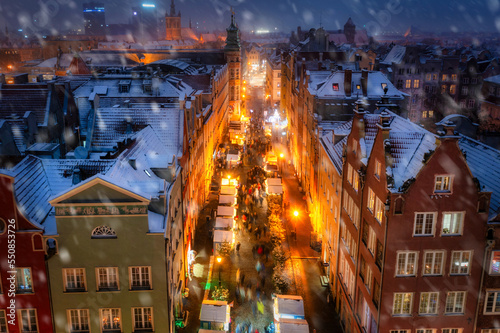 Beautifully lit Christmas fair in the Main City of Gdansk during a snowfall. Poland
