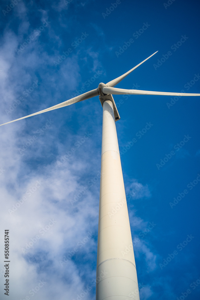 wind turbine close-up view from below against blue sky. Wind power plant. Renewable energy wind turbine close-up view from below against blue sky. Wind power plant. Renewable energy