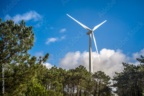 wind turbine close-up view from below against blue sky. Wind power plant. Renewable energy
