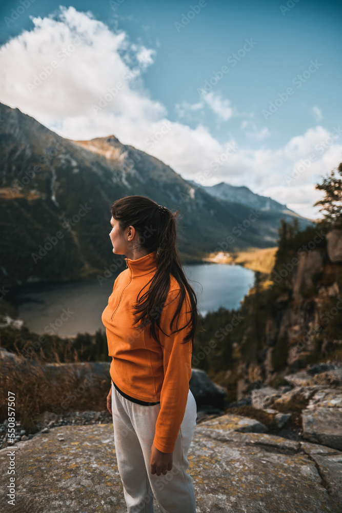 Naklejka premium Pretty woman in the mountains. Concept of hiking adventures in summer.