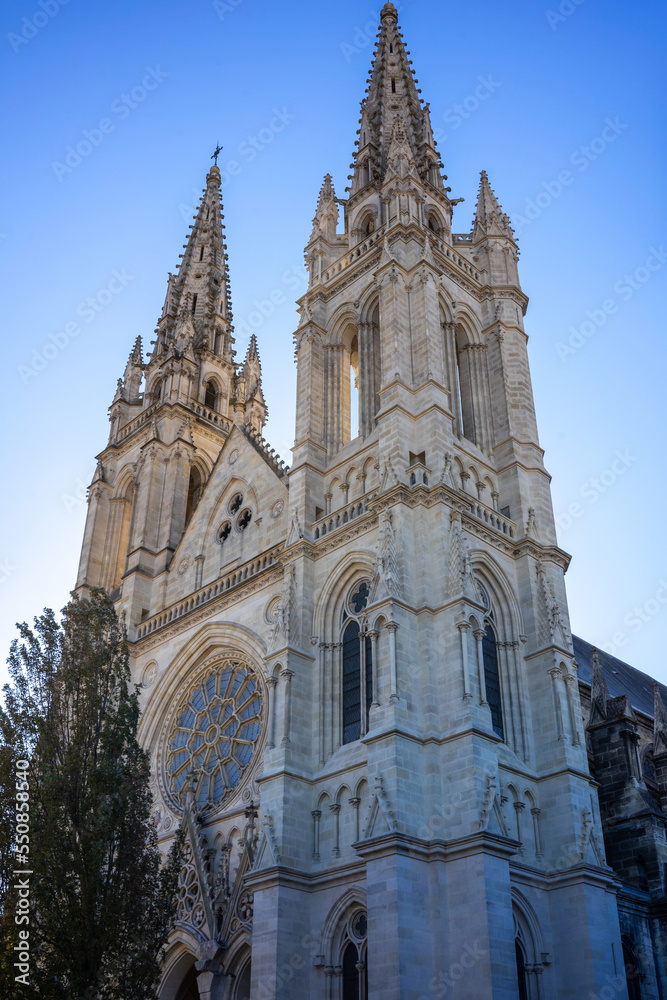 View of the magnificent facade of the 'Église Saint-Louis des Chartrons' church in Bordeaux France. Blue sky in autumn