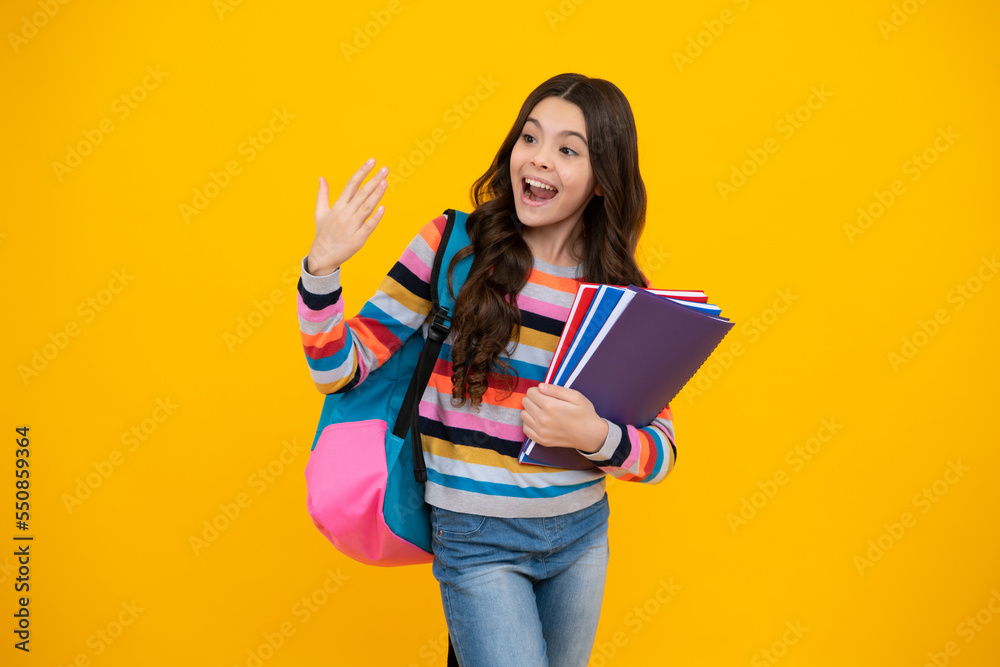 Happy school teenage girl with book and copybook. Teenager schoolgirl student, isolated background. Learning and knowledge. Go study. Education concept. Happy school teenage girl with book and copybook. Teenager schoolgirl student, isolated background. Learning and knowledge. Go study. Education concept.