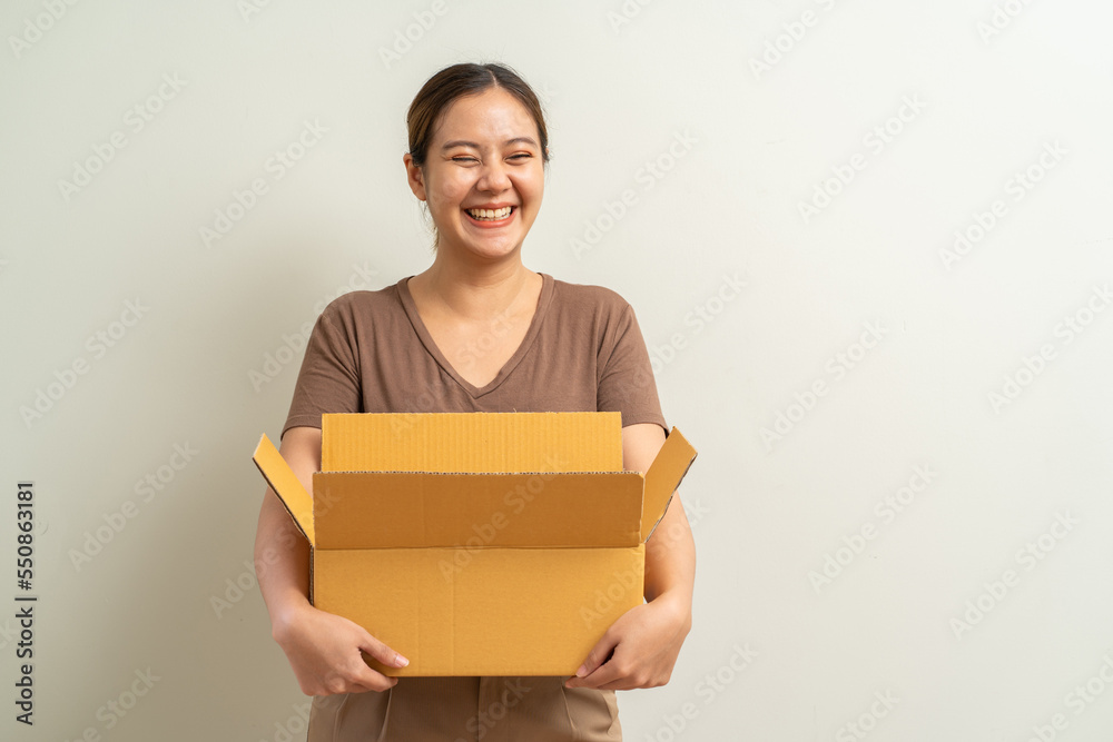 Asian women holding parcel box package, shipment service and delivery courier concept Asian women holding parcel box package, shipment service and delivery courier concept