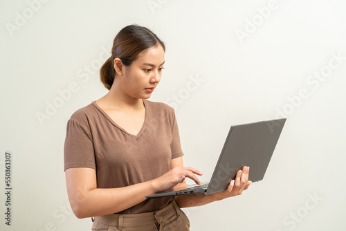 Asian women holding laptop computer. Work from home business concept.