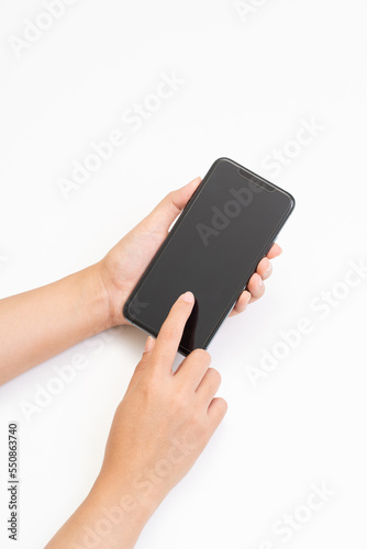 Women hands holding smartphone on white background.