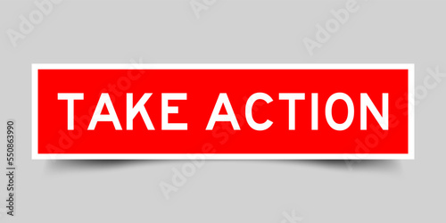 Red color square shape sticker label with word take action on gray background