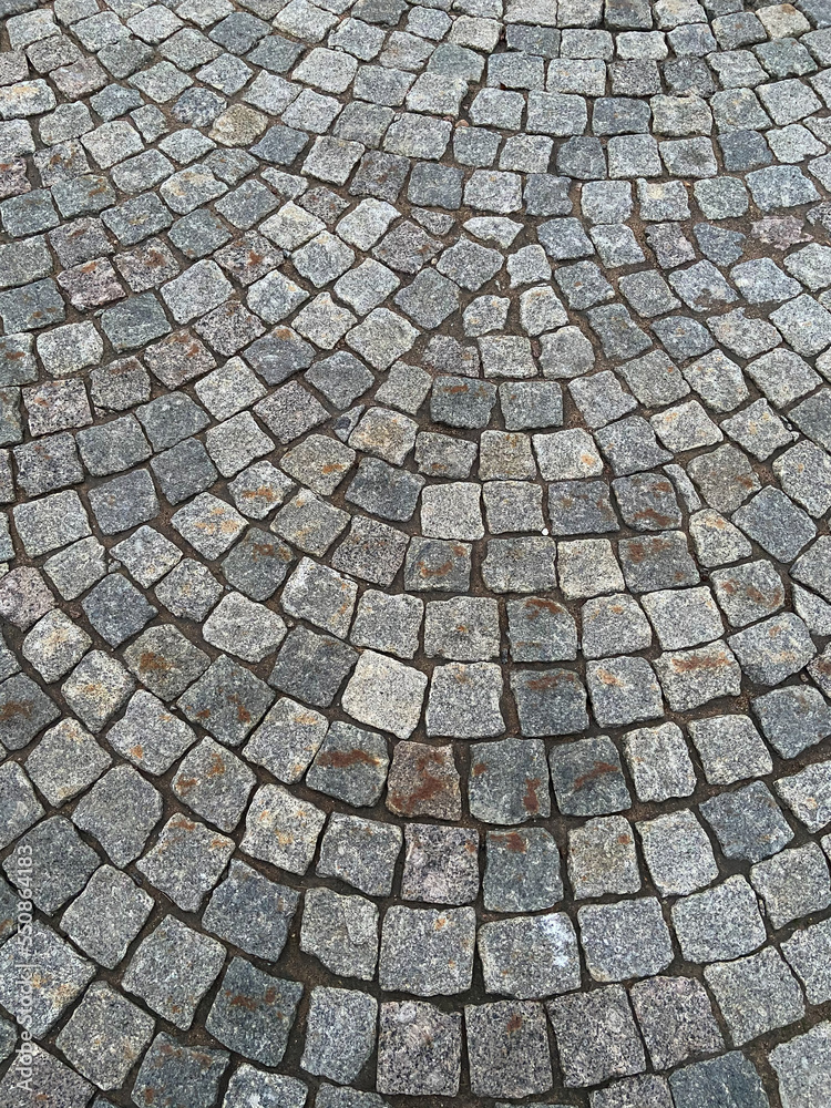 Stone old road, paving stones, closeup. Texture. Fragment of an ancient cobblestone alley. An example of paving from the past. Block paving. In the old days. Historical footprints Stone old road, paving stones, closeup. Texture. Fragment of an ancient cobblestone alley. An example of paving from the past. Block paving. In the old days. Historical footprints