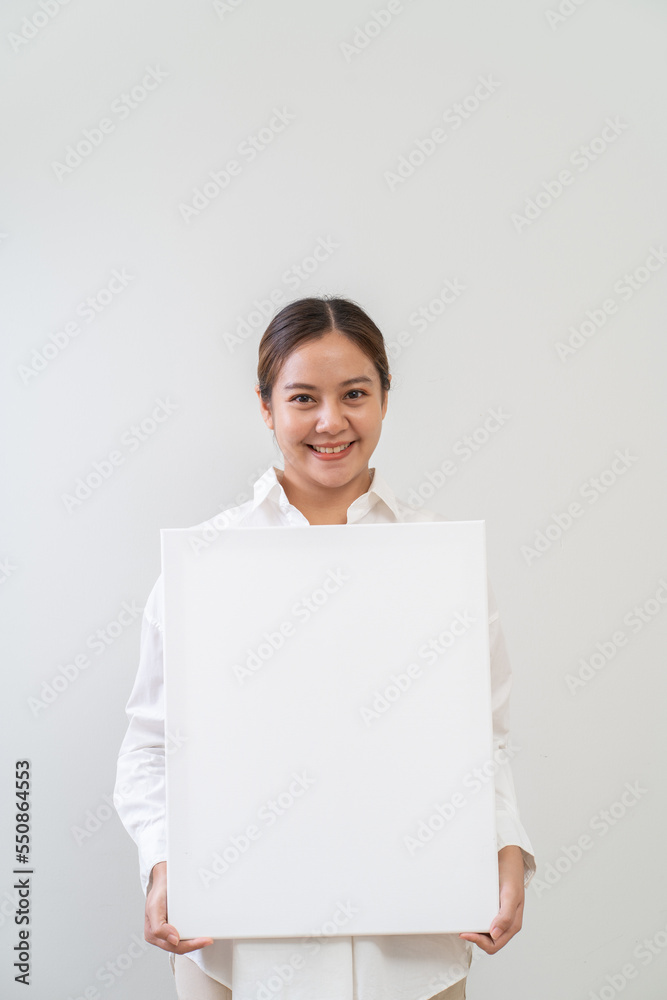 Happy asian woman holding white board. Advertising copy space Happy asian woman holding white board. Advertising copy space