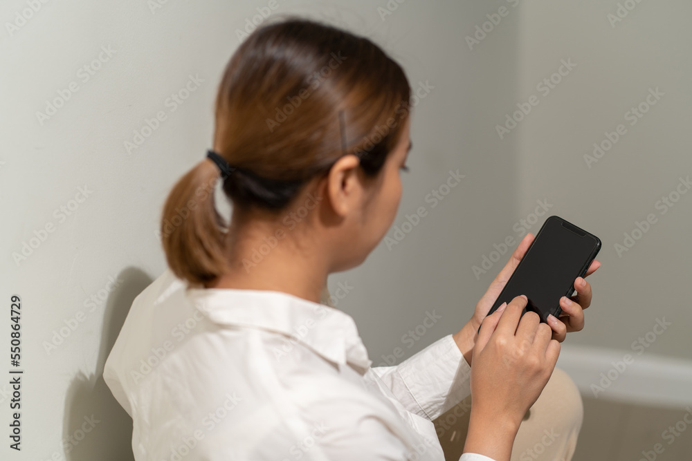 Asian woman using smartphone. working online business. Asian woman using smartphone. working online business.