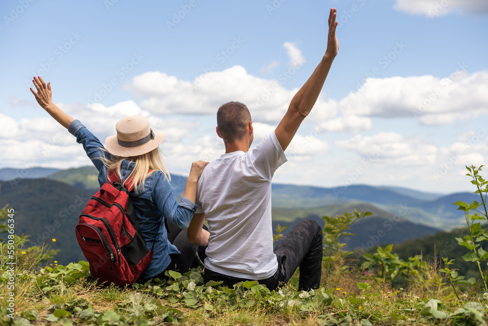beautiful young couple enjoying nature at mountain beautiful young couple enjoying nature at mountain