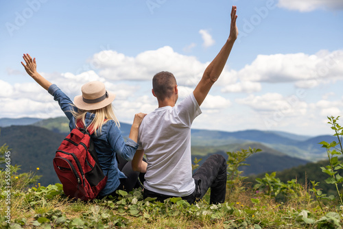 beautiful young couple enjoying nature at mountain