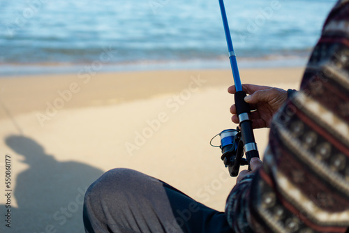 Senior or Middle-aged man fishing at the beach. ビーチで釣りをするシニアまたは中高年の男性