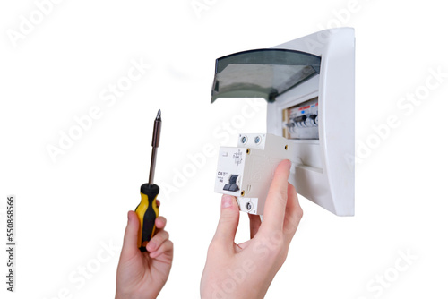 A woman changes an automatic fuse in a home electrical panel, isolated on a white background. Self repair and replacement of electricity equipment in the apartment, diy