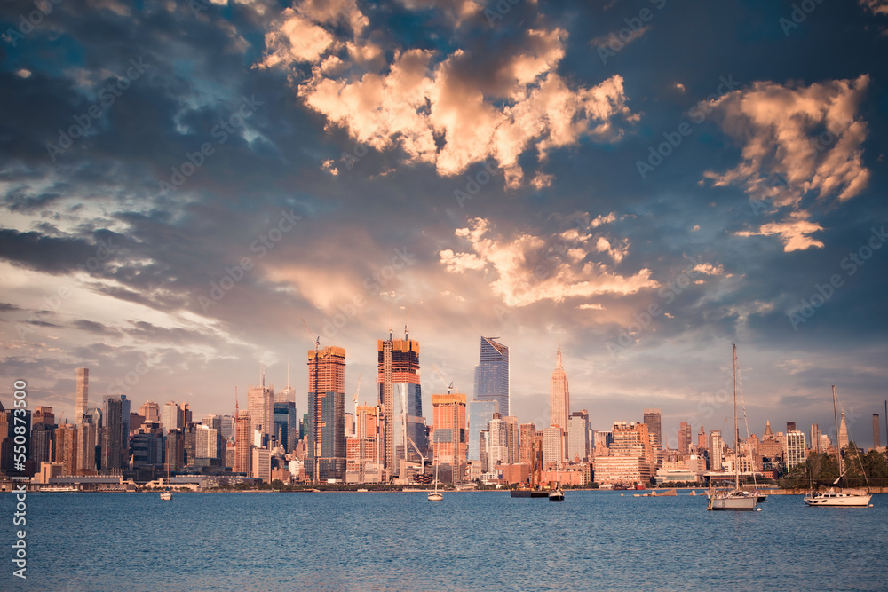 New York City skyline with skyscrapers, new construction, Hudson River  and sunset as seen from New Jersey