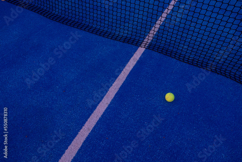 selective focus, a ball on a paddle tennis court at sunset © Vic