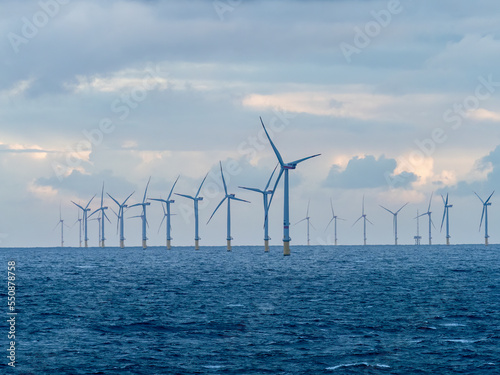 Offshore and Onshore Windmill farm Westermeerwind, Windmill park in the Netherlands with huge large wind turbines, group of windmills for renewable electric energy photo