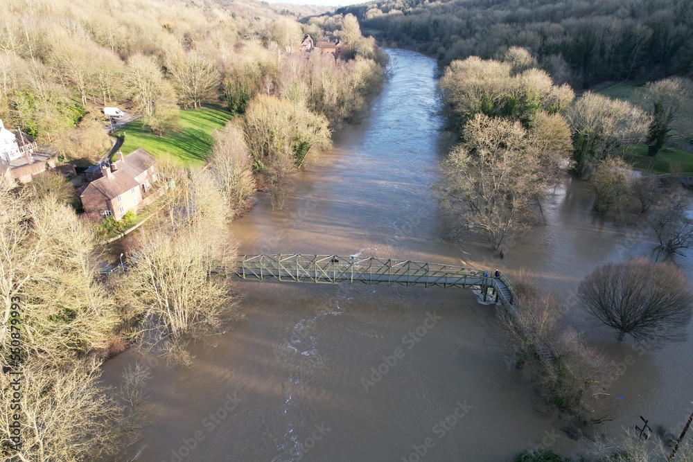 Flooded fields and houses river Severn in Ironbridge England drone aerial view.