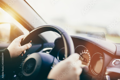 Driver hands on steering wheel driving a car © Photocreo Bednarek