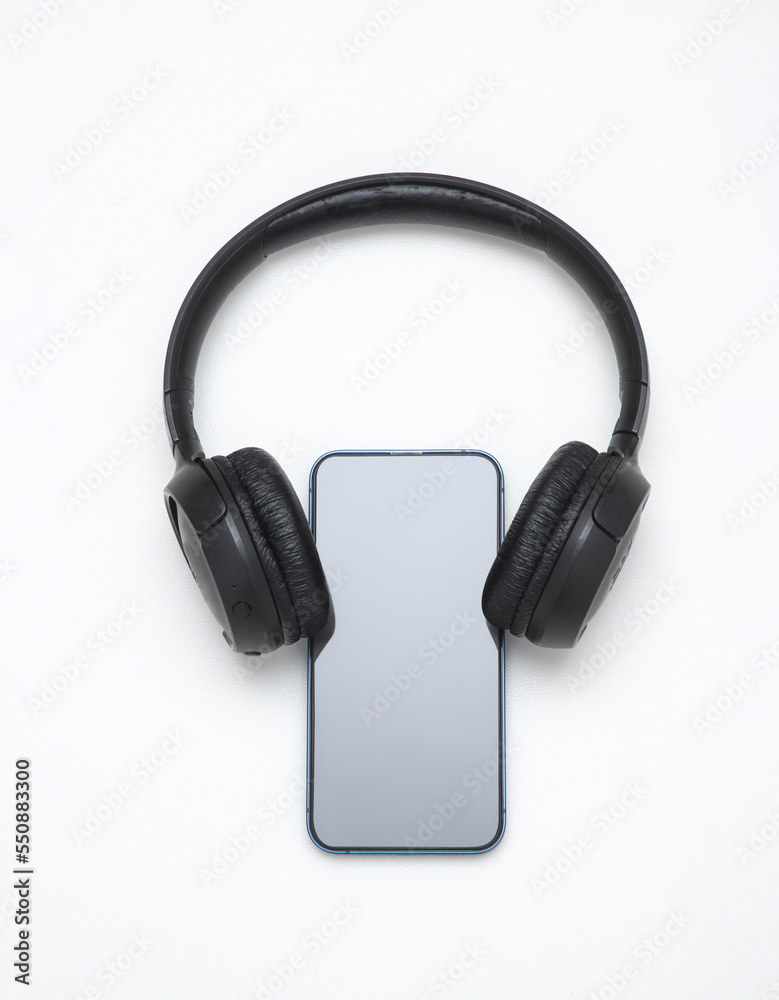 Mockup smartphone display with audio headphones equipment on neon background for banner Mockup smartphone display with audio headphones equipment on neon background for banner