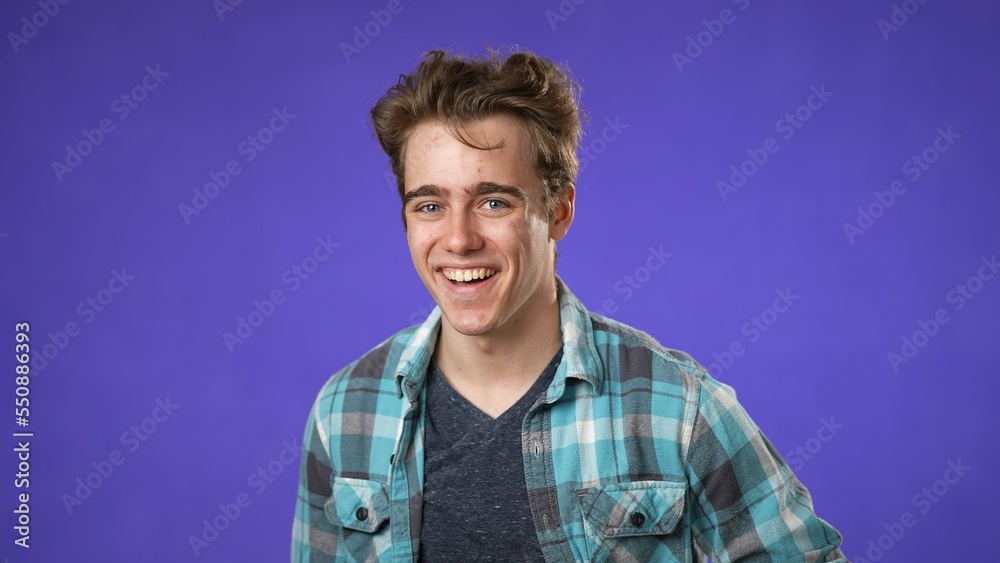 Portrait of smiling happy young hipster man 20s isolated on solid purple background with copy space in studio Portrait of smiling happy young hipster man 20s isolated on solid purple background with copy space in studio