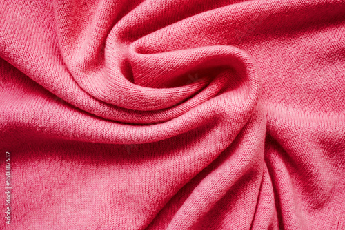The texture of the pink cashmere sweater. Top view, close-up. Сolor Viva Magenta. Demonstrating the colors of 2023.