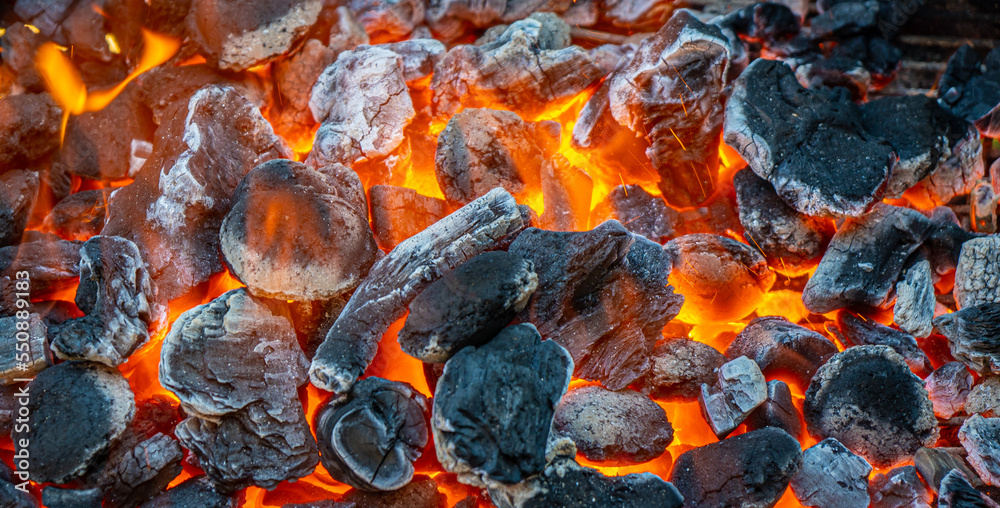 Charcoal and embers burning at full capacity at its peak in a metal barbecue Charcoal and embers burning at full capacity at its peak in a metal barbecue