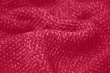 Viva Magenta toned colour monochrome texture knitted fabric. Dark pink knitted Jersey as textile background. Monochrome color background. Wool knitting texture. Trendy color 2023.
