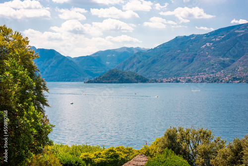 Lake Como in Italy. Natural landscape with trees and mountains by lake