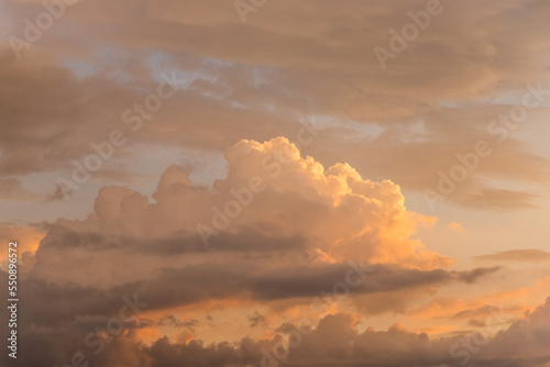orange and blue sky background in the evening or dusk.Natural beautiful bright saturated landscape view of sky sunrise or sunset with yellow orange red lilac clouds flying.