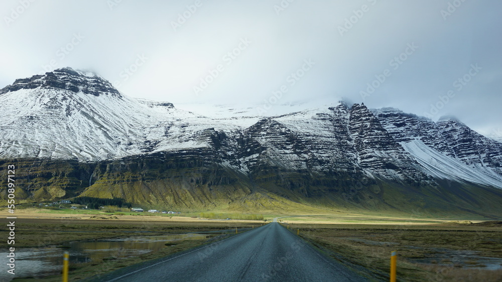 White mountains in iceland. Green grass with snow.
