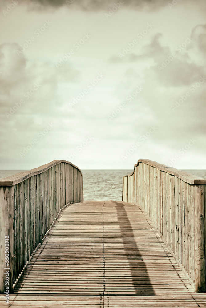 wooden bridge with the sea in the background