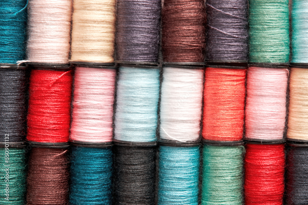 Pink and turquoise colored thread reels pattern texture. Embroidery theme backgrounds Pink and turquoise colored thread reels pattern texture. Embroidery theme backgrounds