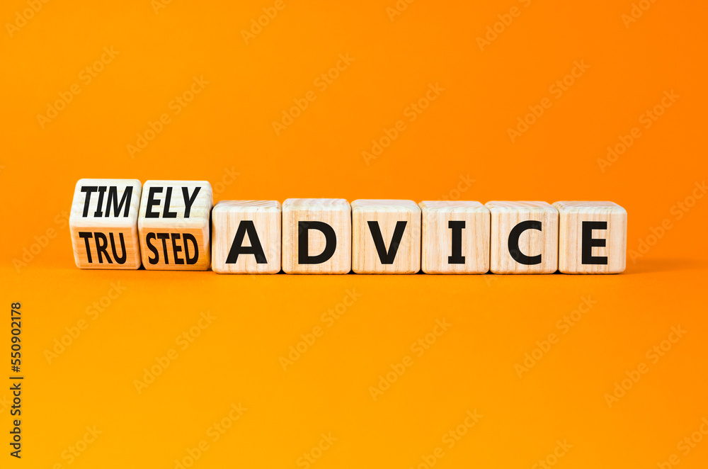 Timely or trusted advice symbol. Concept words Timely advice and Trusted advice on wooden cubes. Beautiful orange table orange background. Business timely or trusted advice concept. Copy space. Timely or trusted advice symbol. Concept words Timely advice and Trusted advice on wooden cubes. Beautiful orange table orange background. Business timely or trusted advice concept. Copy space.
