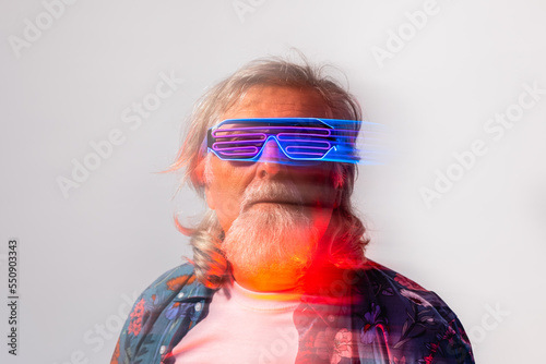 Senior male in led rave glasses in studio