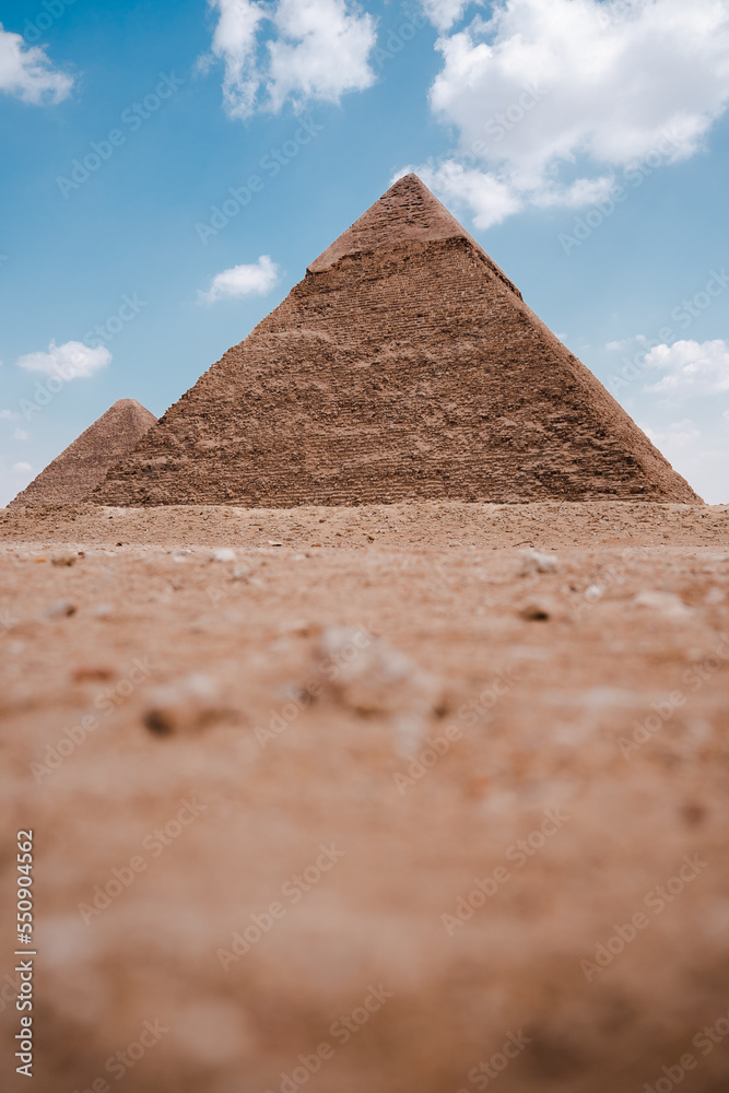 Ancient Egyptian pyramids in desert on sunny day Ancient Egyptian pyramids in desert on sunny day