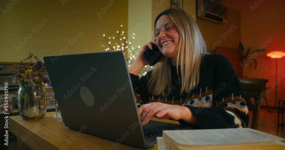 Freelance female worker speak on mobile phone and using laptop computer at home Freelance female worker speak on mobile phone and using laptop computer at home
