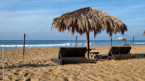 Thatched palapa over a lounge chair in Zipolite  Mexico