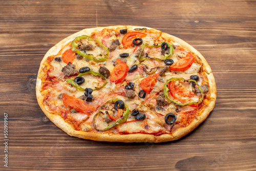 Traditional Italian Pizza with mozzarella, tomatoes and salami over black background, copy space. Delivery pizza or pizzeria promotional concept, Pizza Margherita, top view Pizza Margarita with Tomato