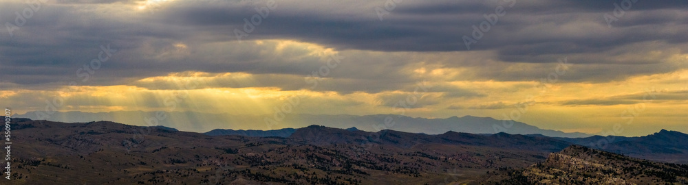 Drone aerial view of a sunset amongst the hills and mountains outside of Cody, Wyoming